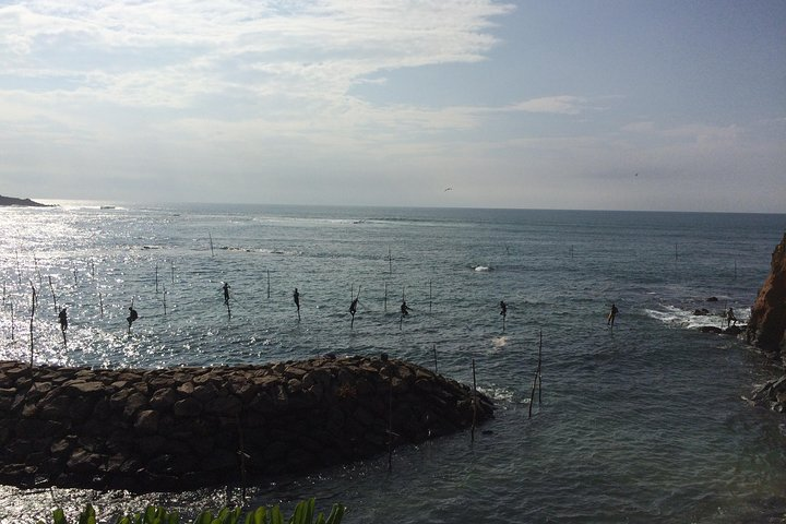 Stilt Fisher mans while put the net 
